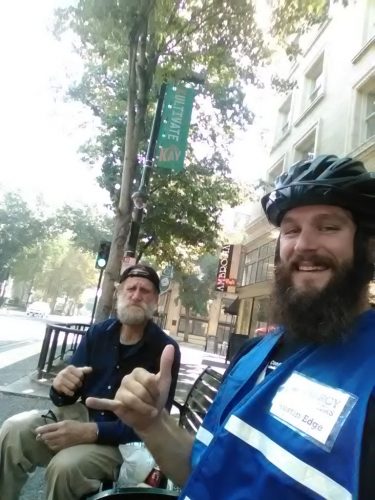 An image of Austin and a homeless man smiling